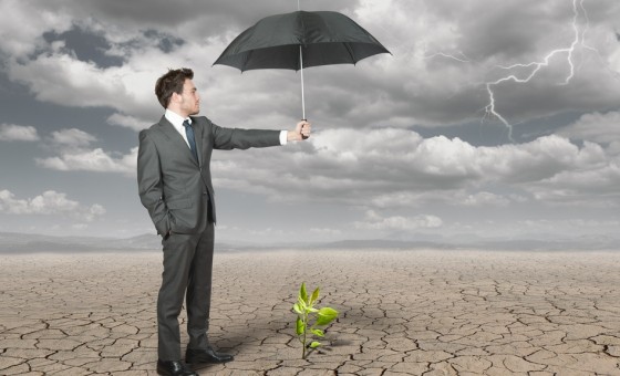 man with umbrella in desert fog