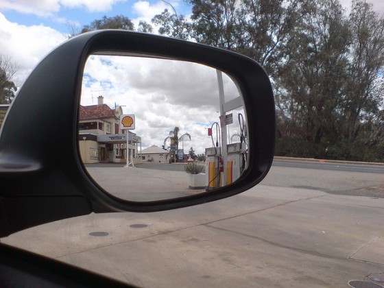 View of petrol station in car side mirror