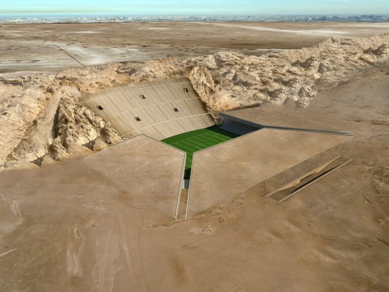 The Rock Stadium Rises from the Desert in Sharp Planes