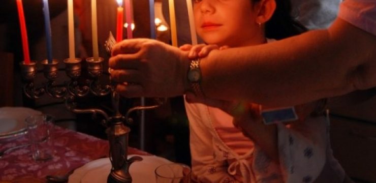 Girl-watching-lighting-of-Hannukah-Mennorah.jpeg