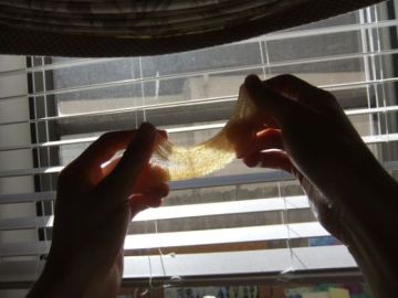 Sugar wax pulls, arabic waxing, sugaring, pulling the candy wax in the light to see