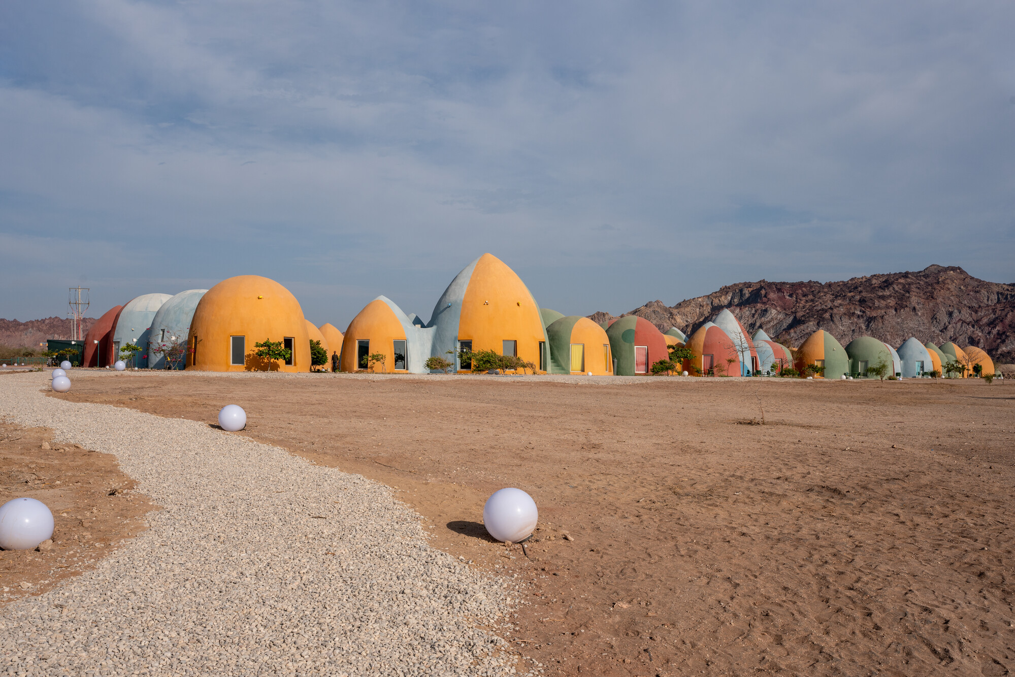 Hormuz Island, Majara Residence, ZAV Architects, sustainable architecture Iran, Hormuz eco tourism, Aga Khan Award architecture, Superadobe construction, Nader Khalili, earth architecture, desert architecture, Persian Gulf island, eco resort Iran, sustainable tourism Hormuz, coastal development Iran, turtle nesting beach Hormuz, hawksbill turtle Iran, green turtle Persian Gulf, marine conservation Iran, biodiversity Hormuz Island, wildlife mapping tourism, ecological design architecture, climate responsive design, off grid architecture, local materials construction, community based tourism Iran, cultural tourism Hormuz, Iranian architecture innovation, sustainable building materials, natural building techniques, coastal ecosystem Iran, environmental impact architecture, regenerative tourism, island conservation, soil composition beach, coastal geomorphology Hormuz, Persian Gulf ecology, NGO conservation Iran, participatory conservation, invasive species removal, Prosopis juliflora Iran, native reforestation, mangrove ecology Gulf, sustainable wastewater treatment, composting systems eco resort, circular economy tourism, low impact development, resilient architecture, autonomous eco systems design, marine habitat protection, sustainable infrastructure Middle East, eco architecture photography, architecture detail Superadobe, construction techniques earth dome