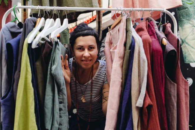Nina Skibnevsky in a pile of clothes made from hemp