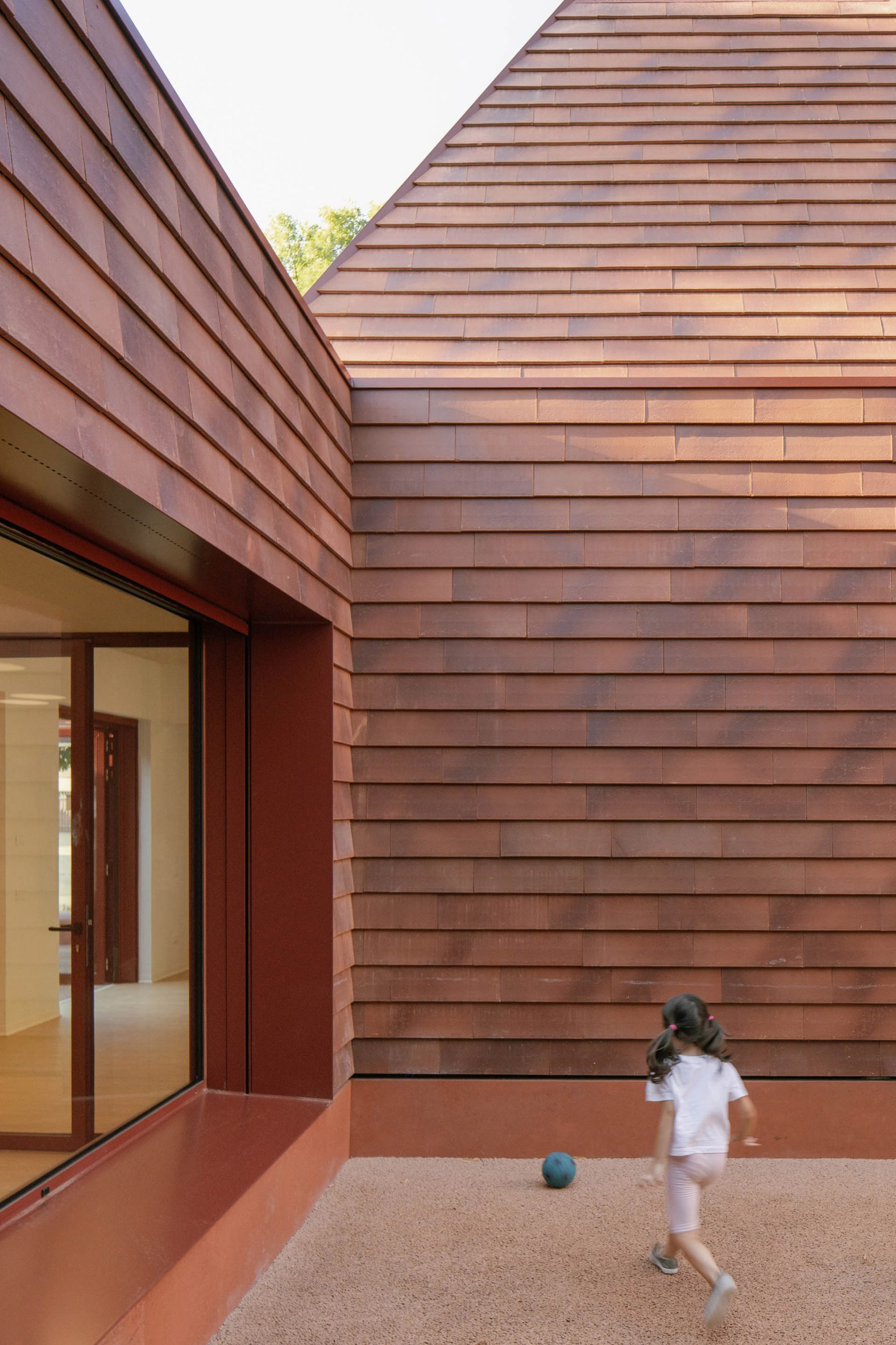 Kinder Rain, a terracotta, vernacular-inspired play space