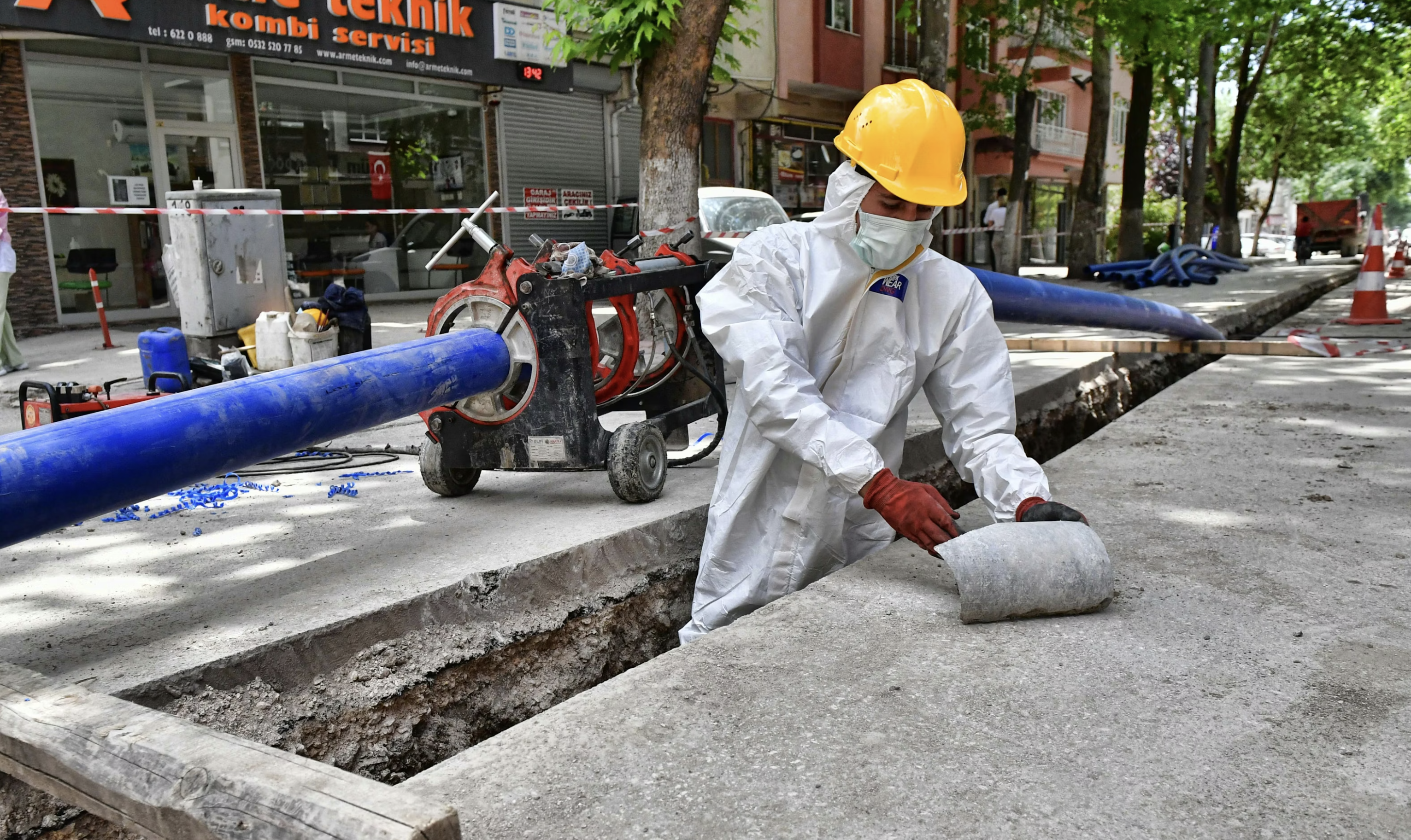 Cleaning up asbestos pipes. Asbestos particles can cause lung cancer.