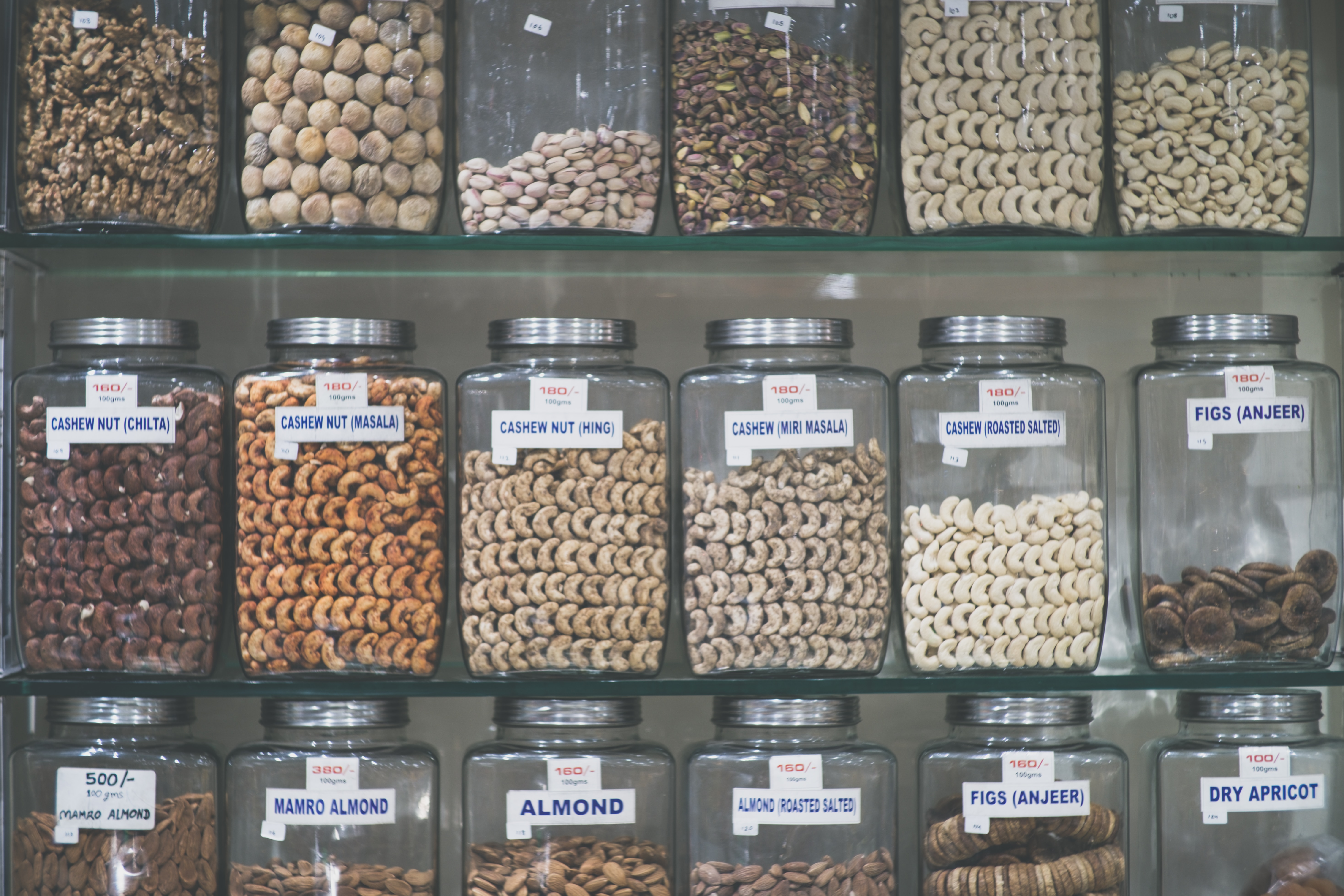 all kinds of nuts on a shelf, dairy alternatives, almond, cashew
