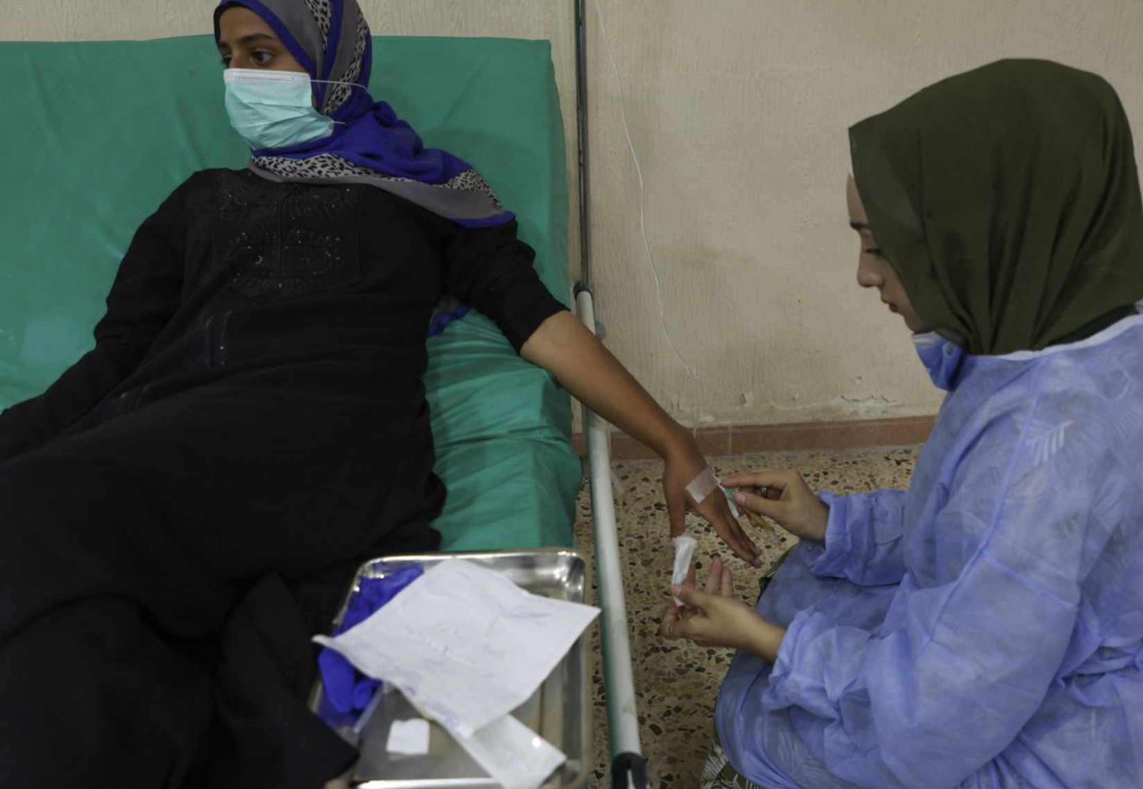 Cholera in Lebanon, woman in the north gets IV from a healthcare worker