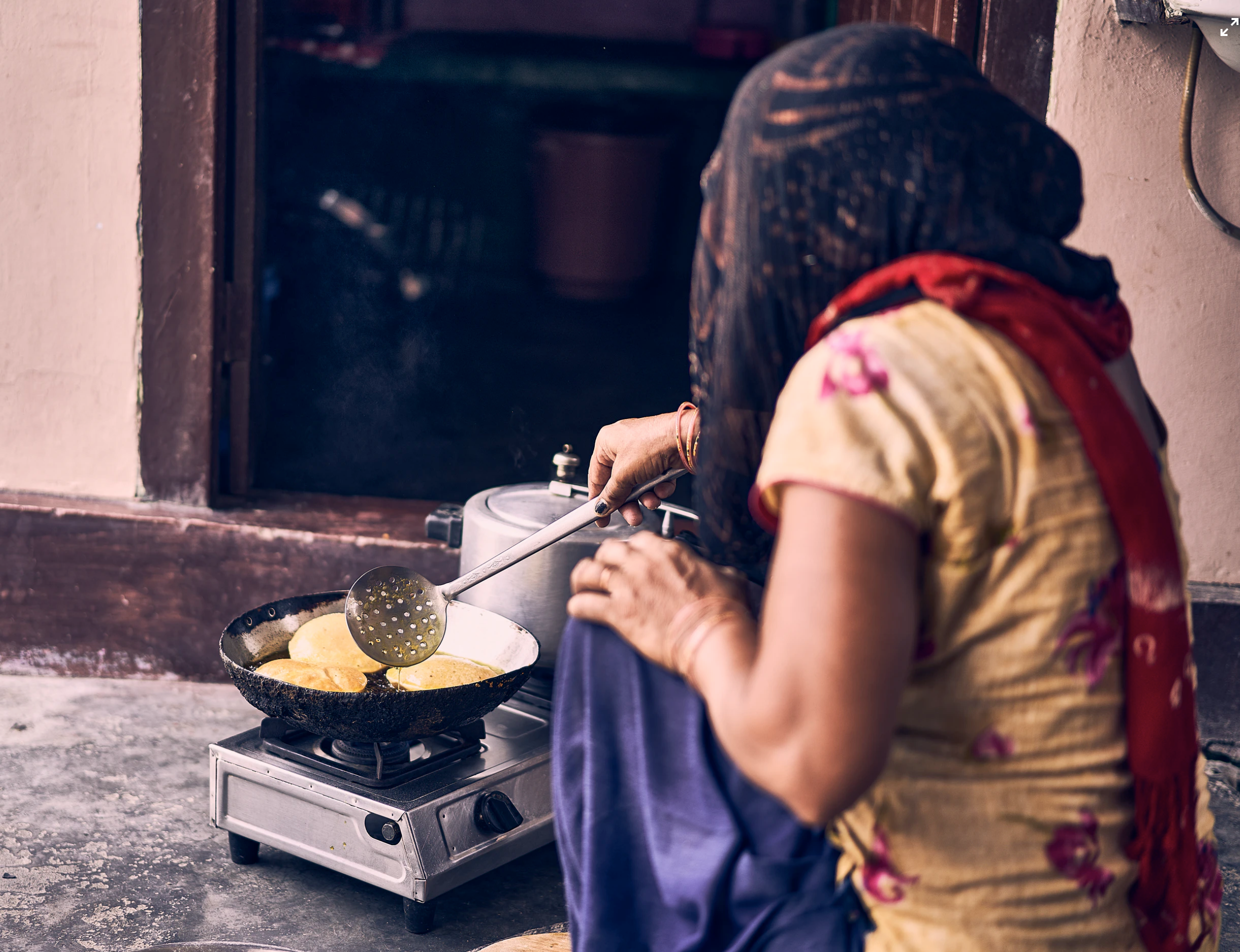 India woman cooking with oil