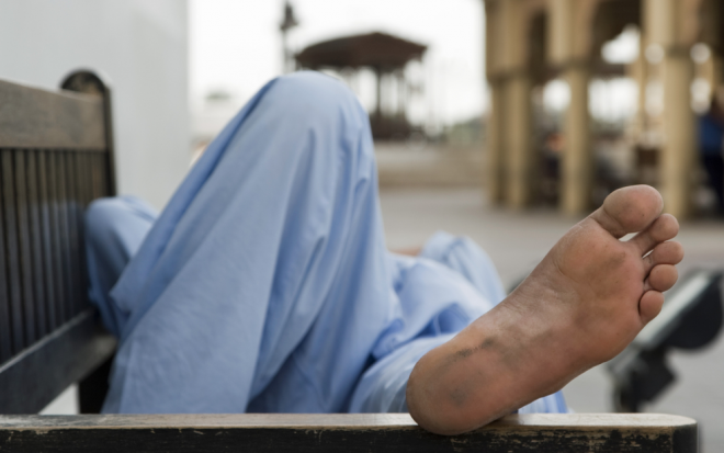dubai guy sits on a bench