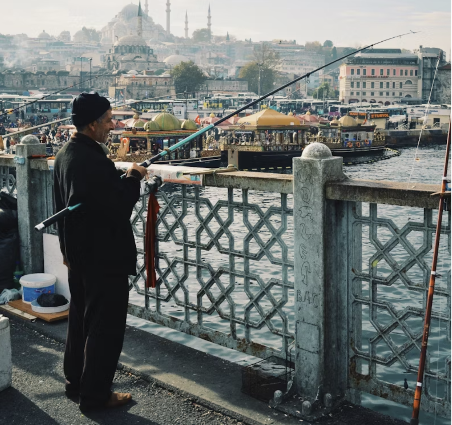 man fishing in polluted water Istanbul