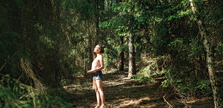 forest bathing, OCD therapy, woman hipster contemplating nature in dark green forest