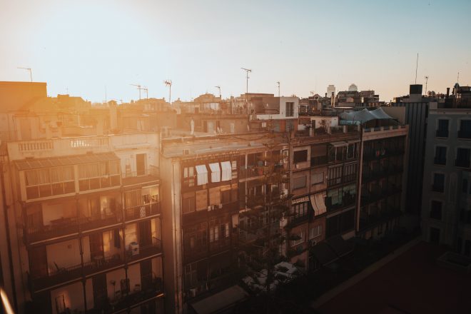 sun on roofs of apartments in barcelona