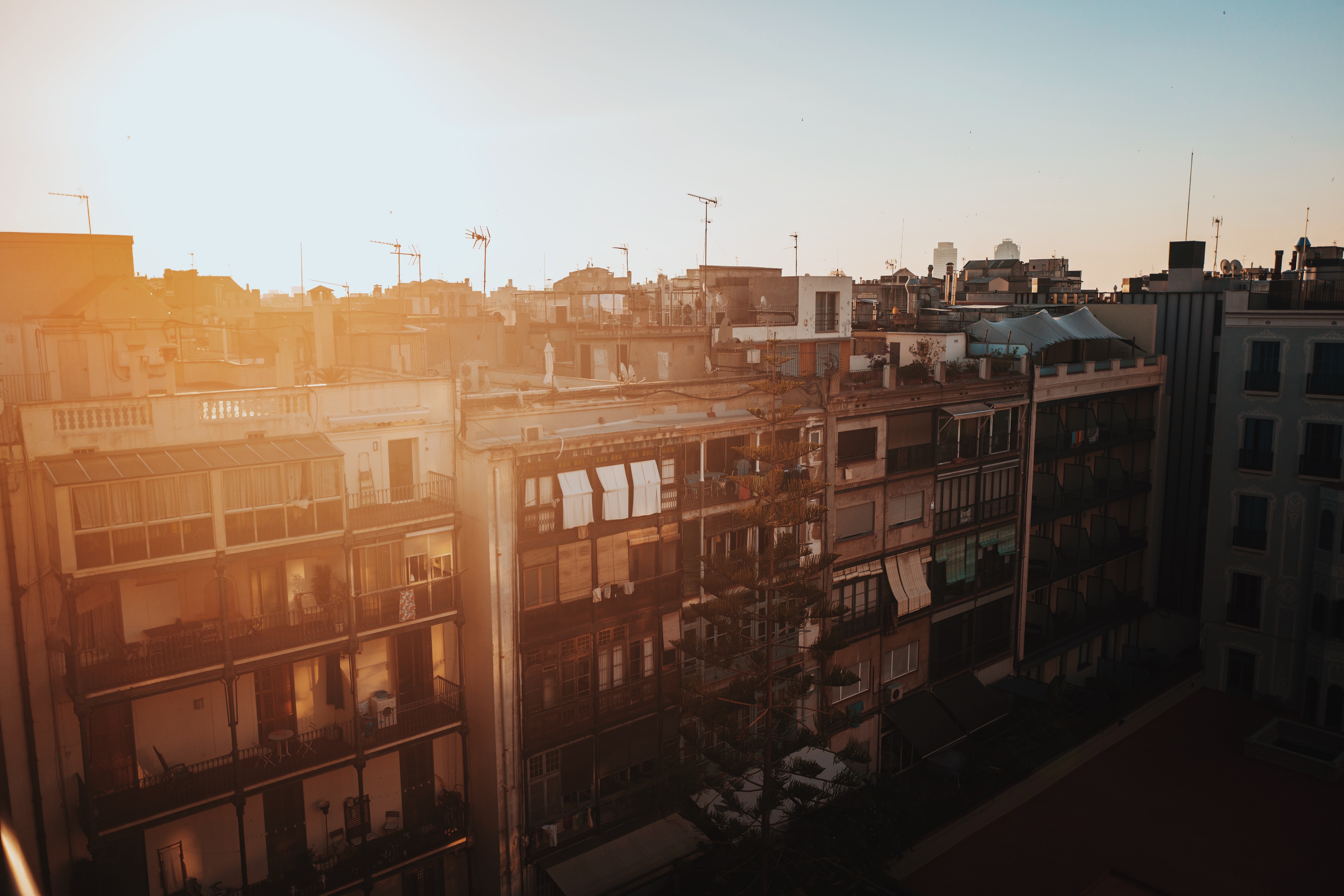 sun on roofs of apartments in barcelona