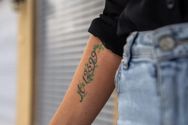 Orly Weintraub Gilad has her grandfather's Auschwitz number, A-12599, tattooed on her arm. John Jeffay for the Conversation