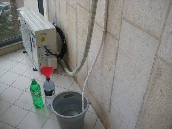 An image showing how to collect AC water, ac water uses, air conditioner water reuse, condensate water, how to use AC water, AC condensate water, air conditioner water for plants, HVAC water recycling, alternative water sources, atmospheric water harvesting, sustainable water solutions, reuse air conditioner water, distilled water from AC, drought solutions, water conservation ideas, condensate recovery systems, eco friendly water reuse, urban water recycling, AC water for gardening, graywater alternatives, climate adaptation water