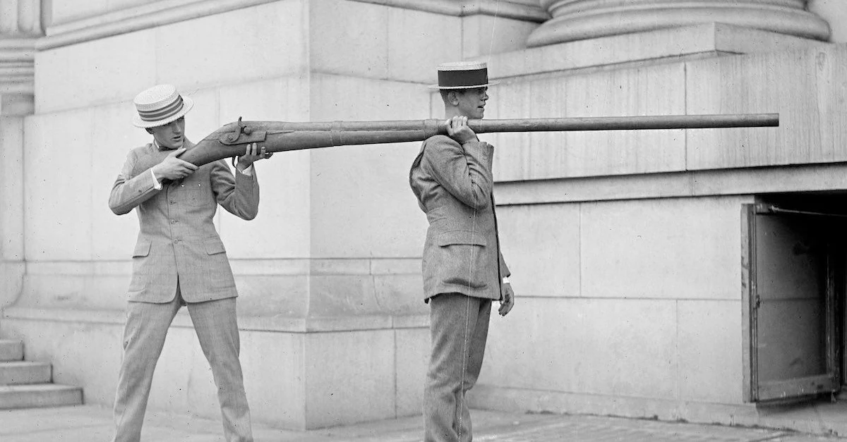 2 guage shotgun, gun, 2 men holding it