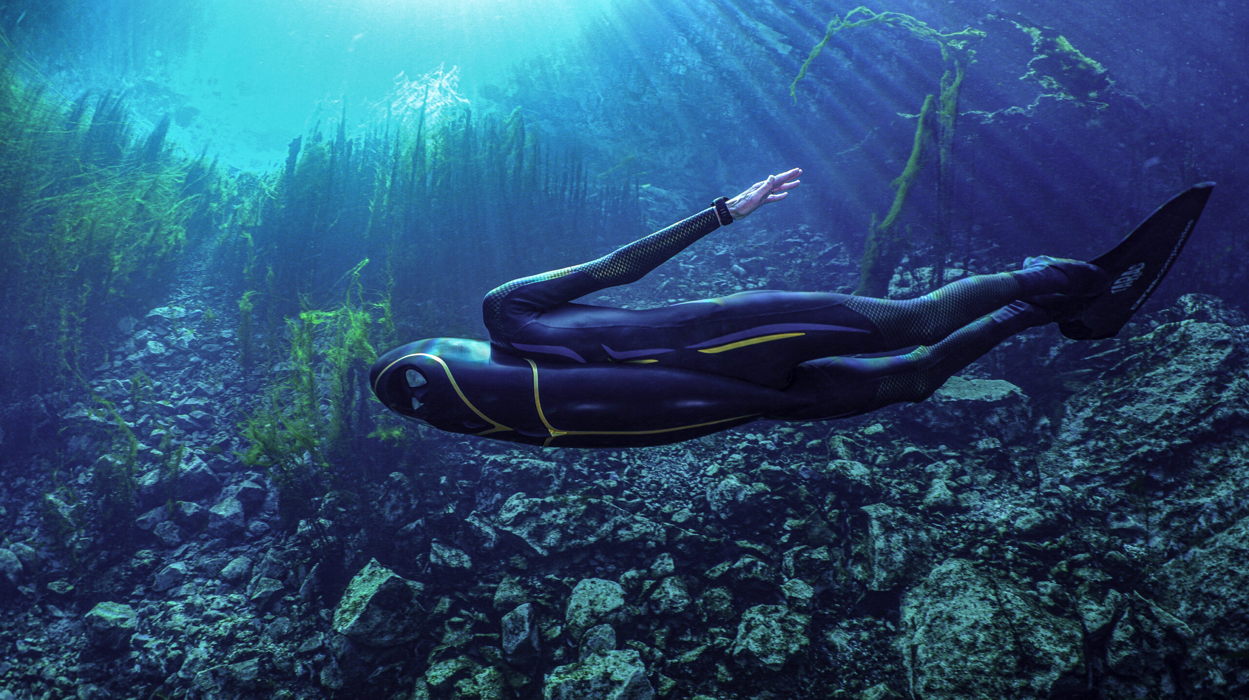 Isler under water wearing the oddly shaped, by aerodynamic rebreather