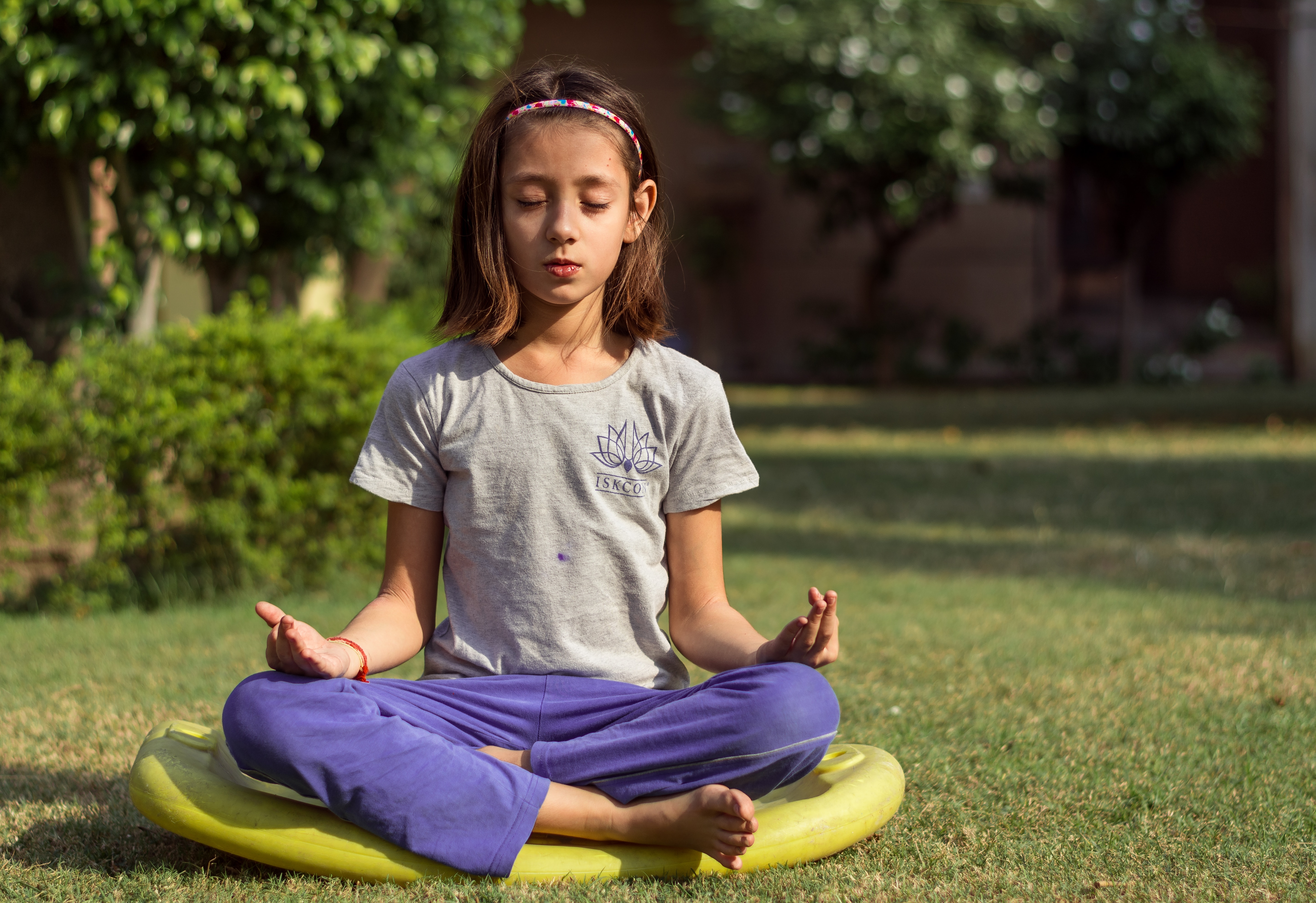 girl in lotus position yoga saying om