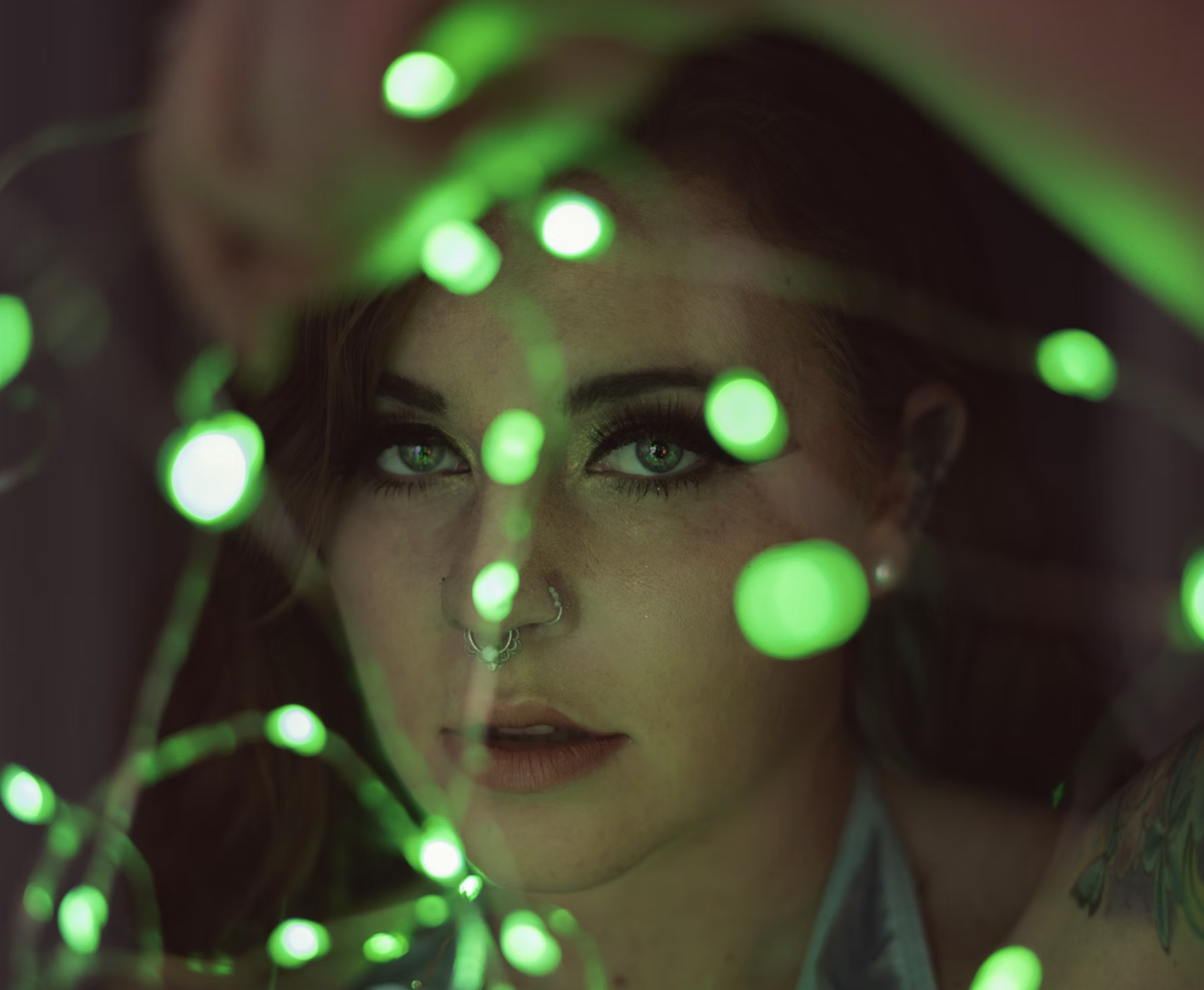 LED lights on a woman's face, green lights, nose piercing