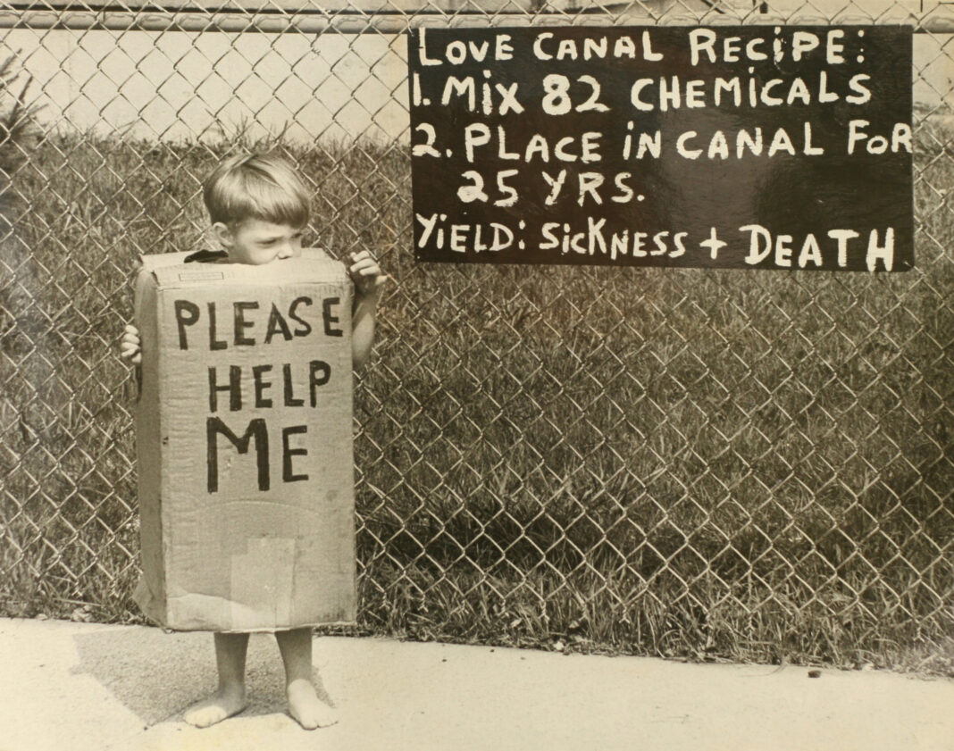 Love Canal USA, a child holding a sign saying please help me