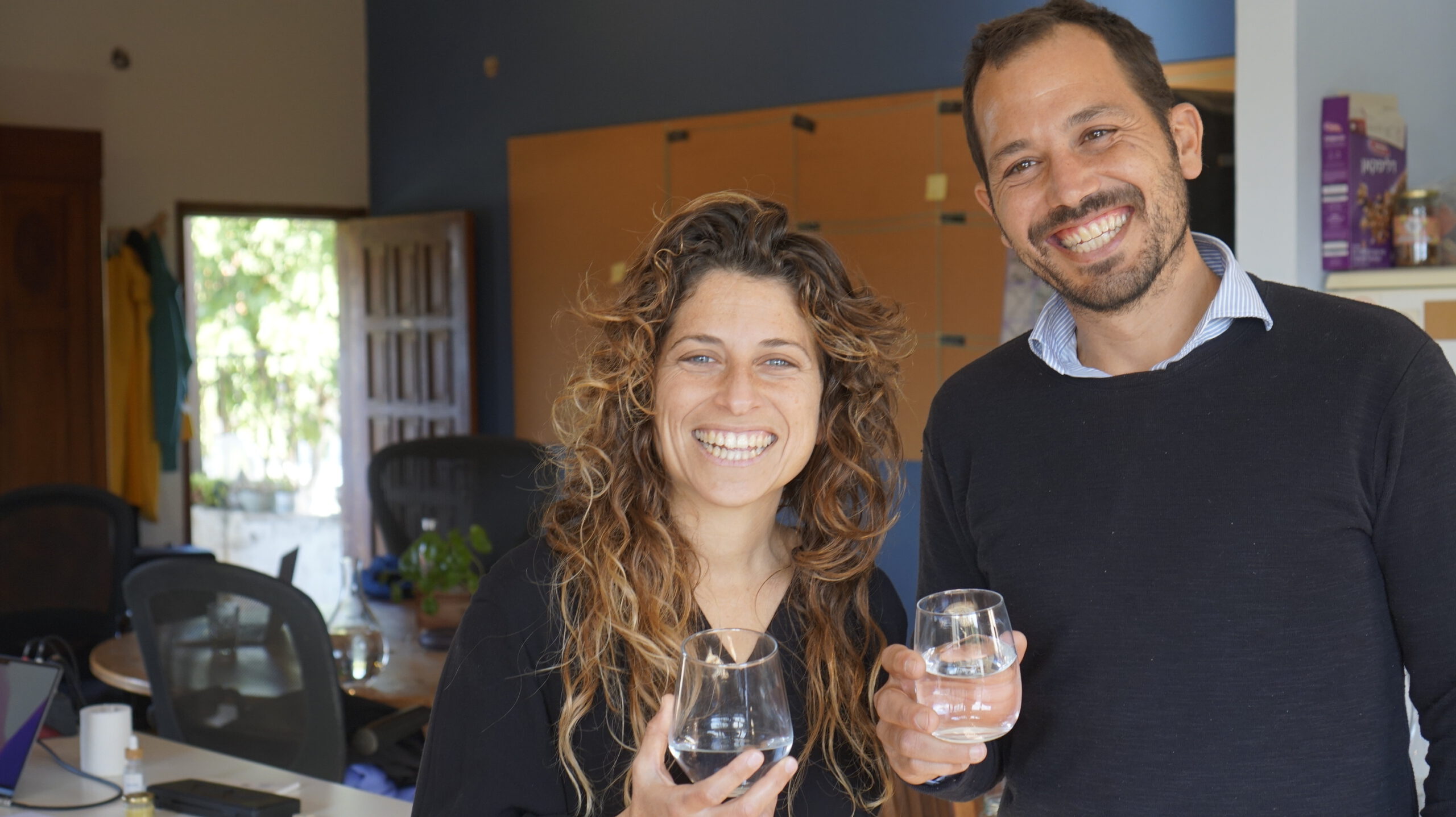 Mayu founders Ze'ev Zohar and Shay Eden, holding a glass of water, cheers