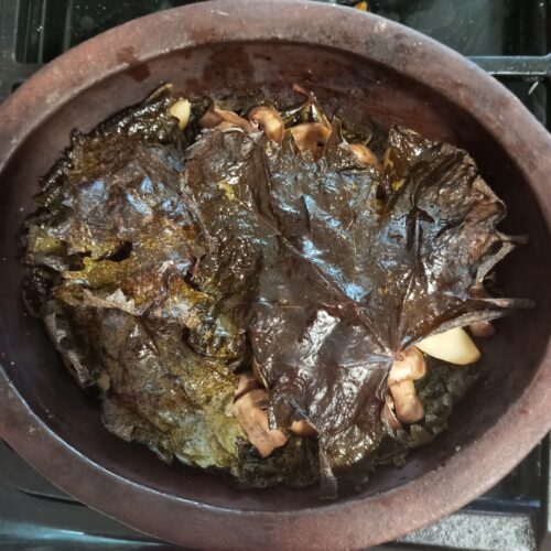 mushrooms covered in grapevine leaves
