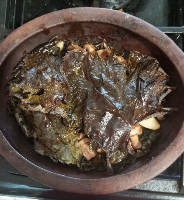 mushrooms covered in grapevine leaves