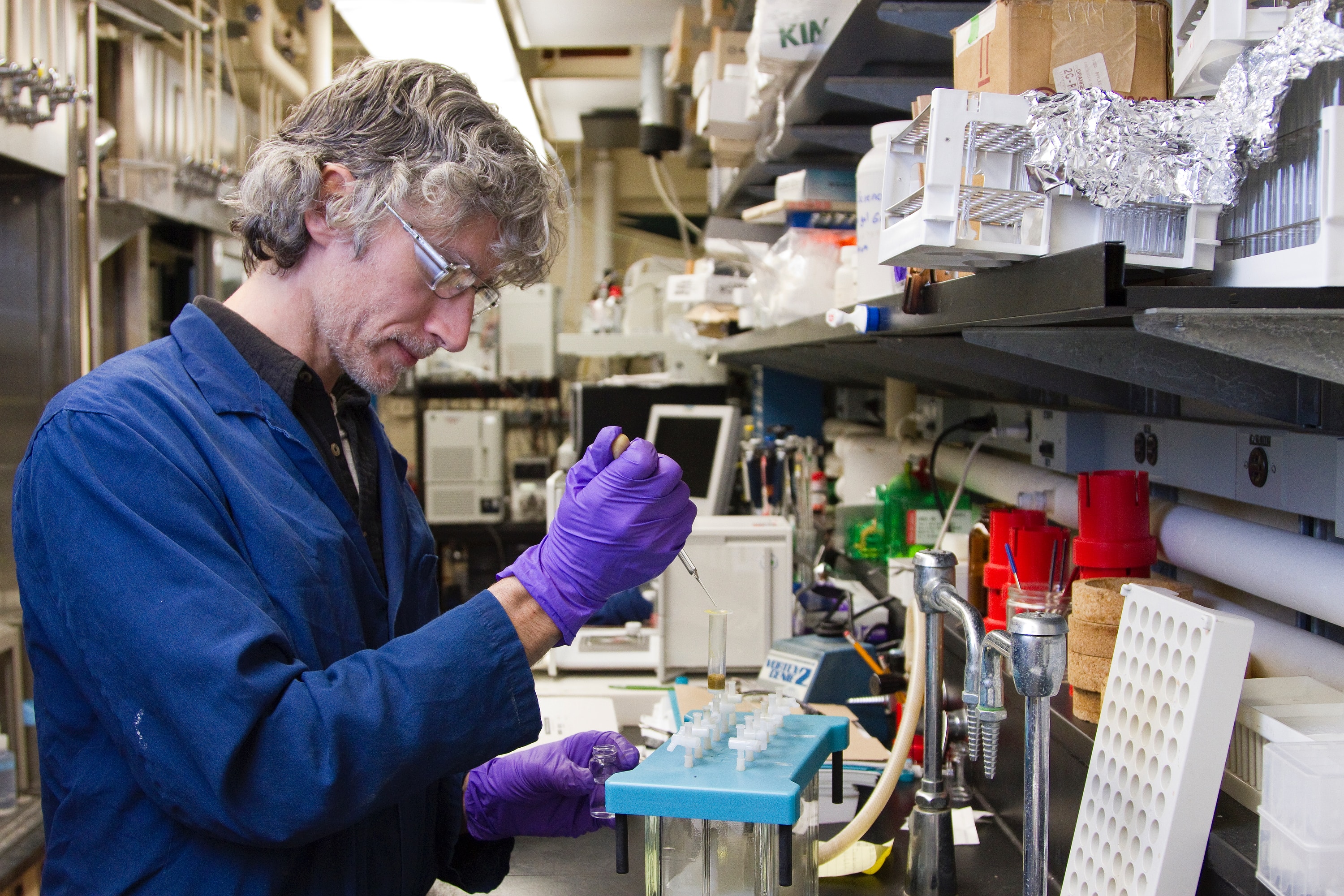man testing bacteria resistance with pipettes in lab