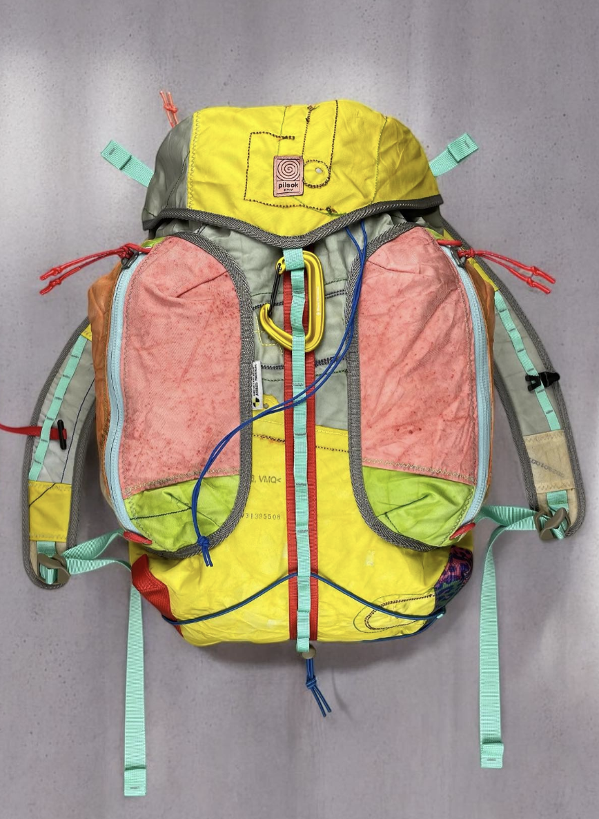 Pilsok beetle bag made from upcycled car airbag nylon, showing original seams and fabric codes, handmade in Kyiv Ukraine