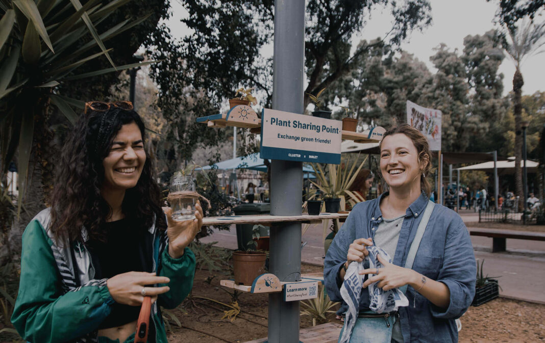 plant sharing two women holding pots