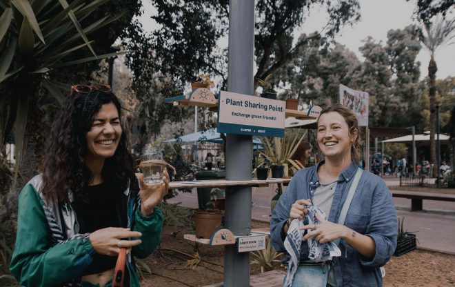 plant sharing two women holding pots