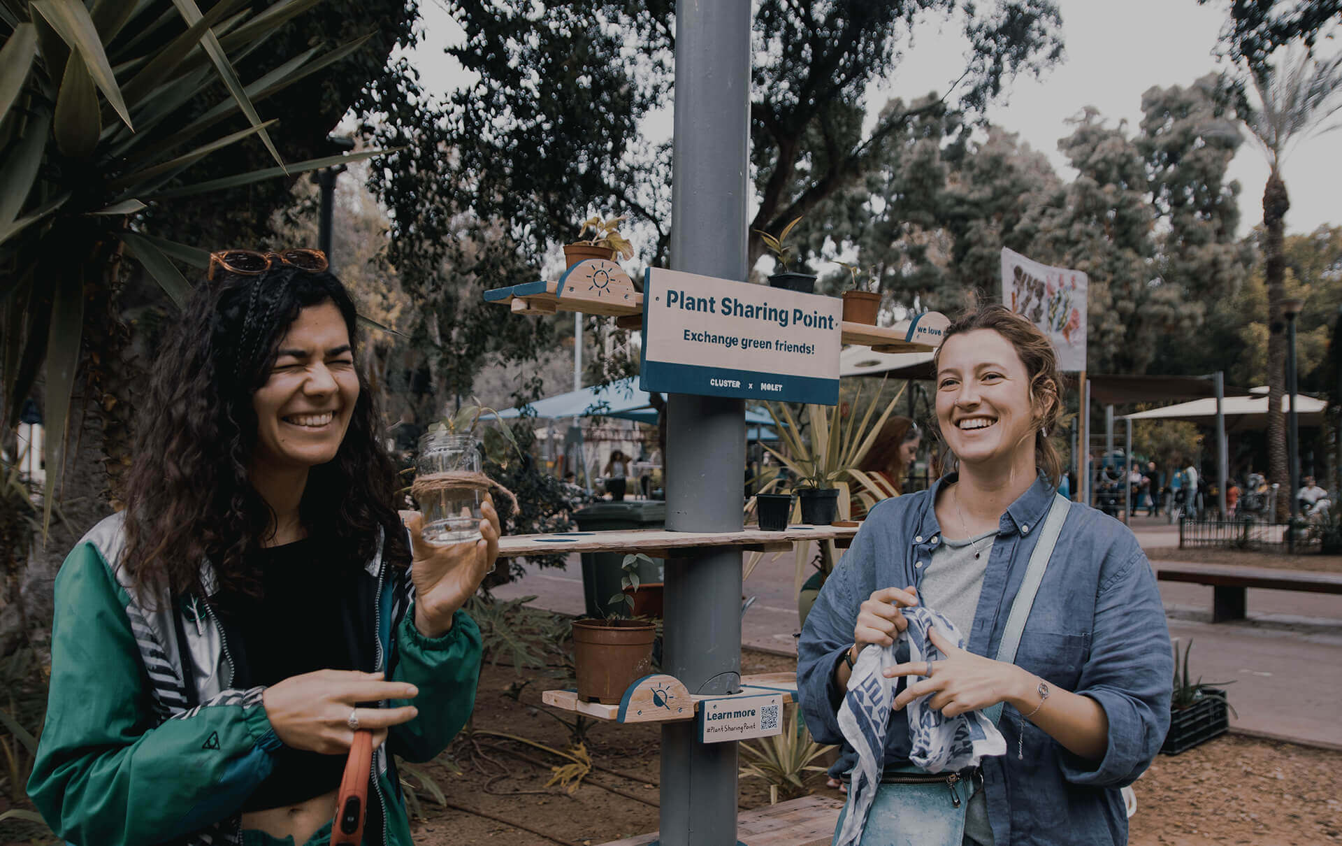 plant sharing two women holding pots