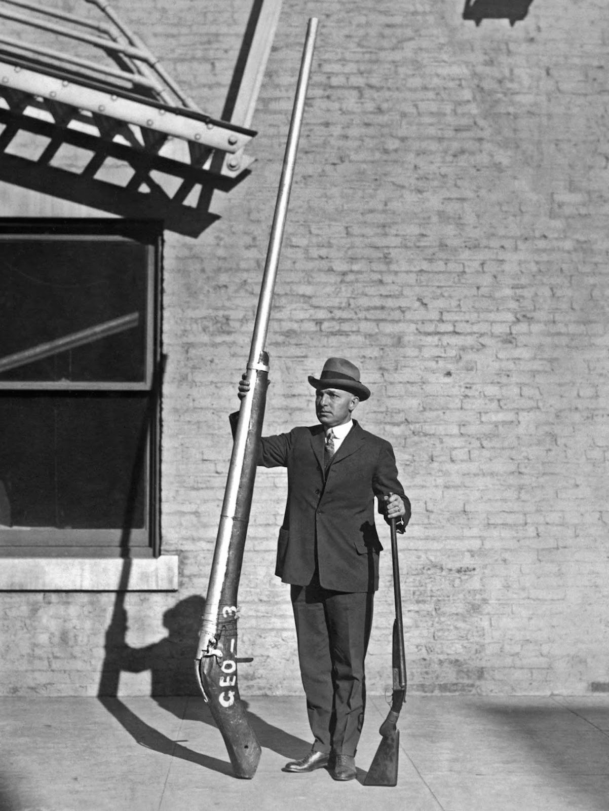 Chief United States Game Warden George A. Lawyer, with an illegal 10’9″ shotgun weighing 250 pounds, which was used for duck hunting. 1920.