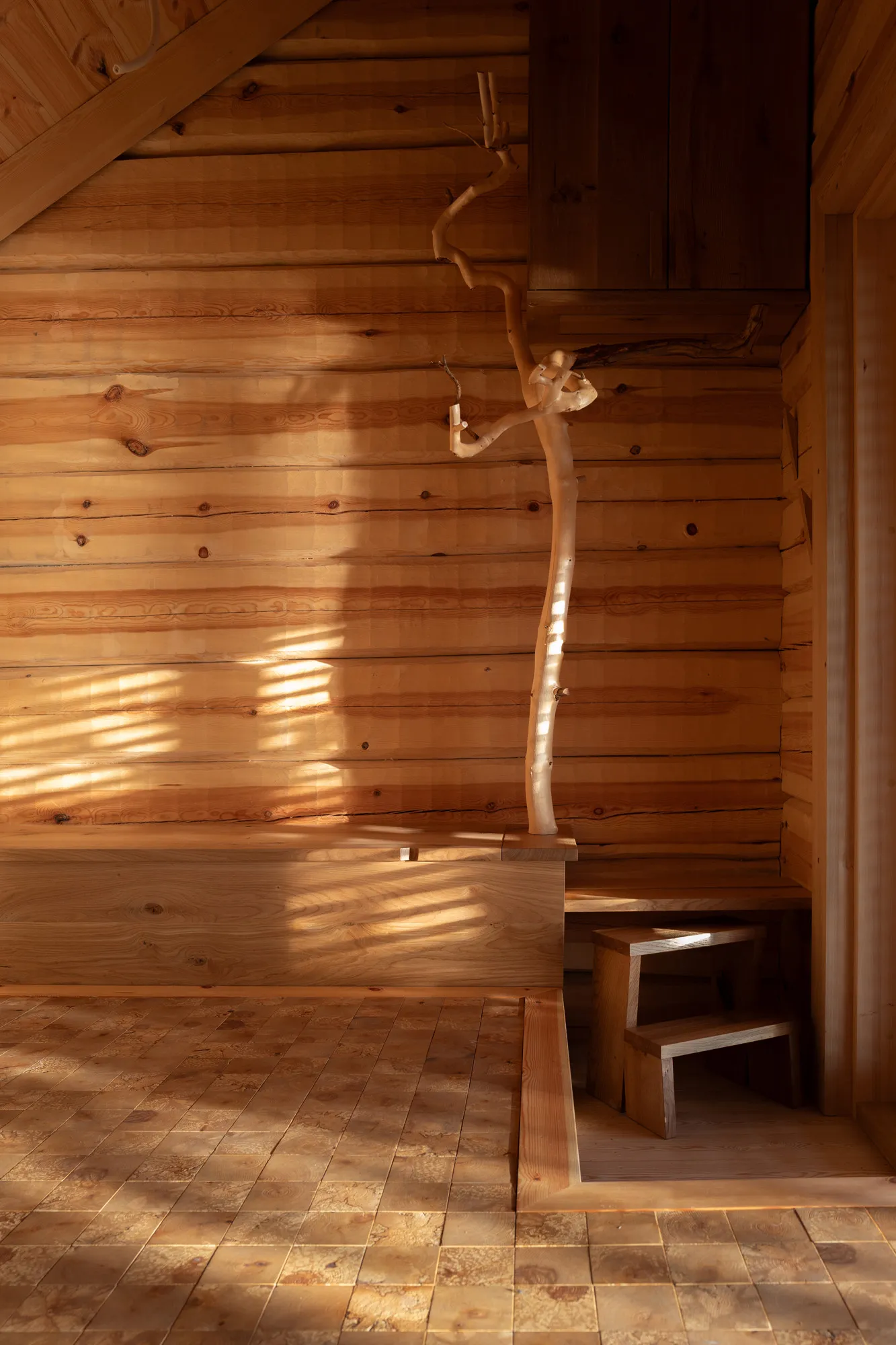 Puusauna showcases how naturally shaped timber can become a celebrated architectural feature rather than a construction defect. (Image credit: Teppo Lakanniemi)