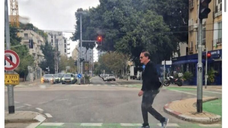 Quintin Tarantino walks on a bike lane in Tel Aviv