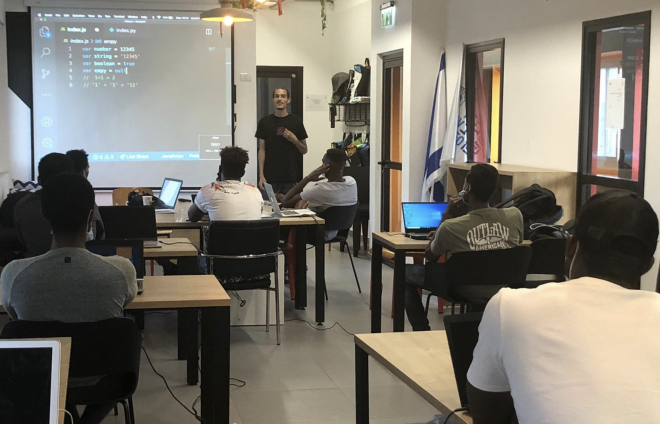 refugees learning code in a classroom in tel aviv