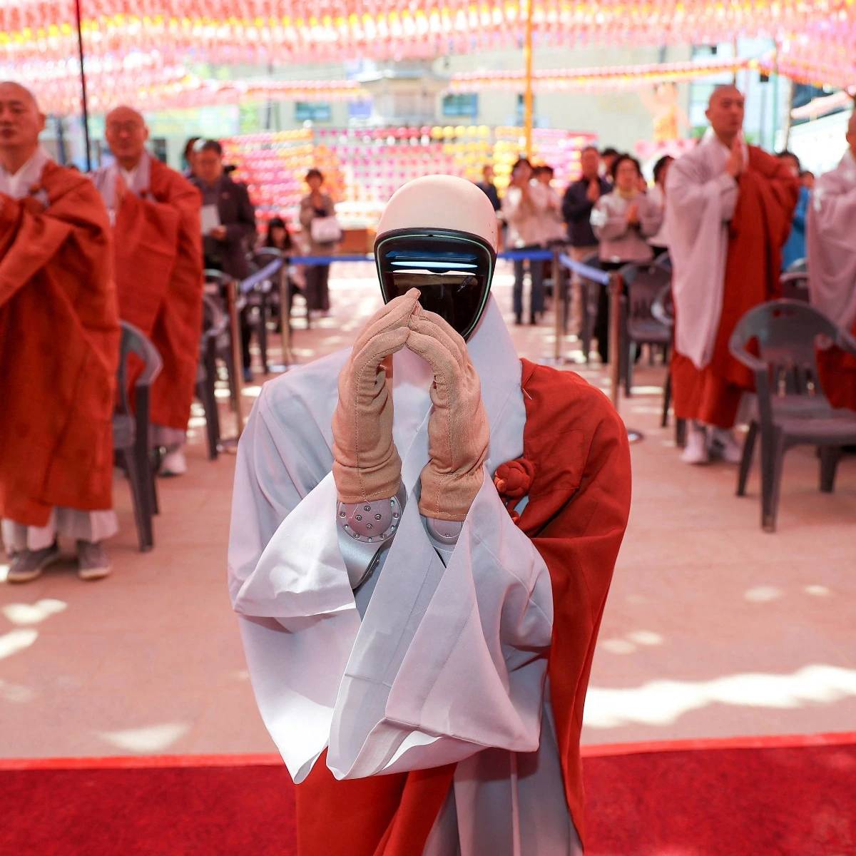 Gabi the robot monk at Jogyesa Temple in Seoul – A humanoid robot dressed in gray Buddhist robes stands with palms together in prayer inside South Korea’s Jogyesa Temple during a symbolic ordination ceremony.