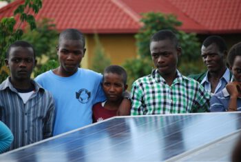 Children in Rwanda looking at solar panel