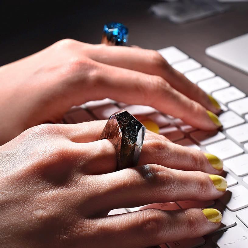green jewelry, hands on keyboard