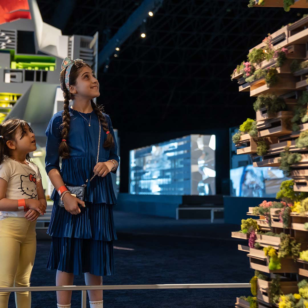 Children look at model of The Line, a 15-minute city part of Neom, Saudi Arabia
