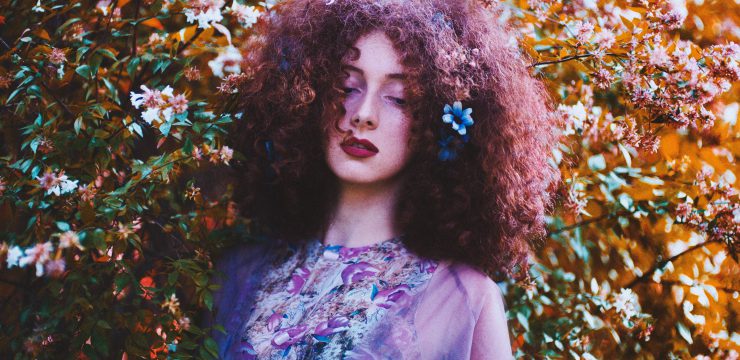 beautiful woman in the flowers, maybe she is a herbalist