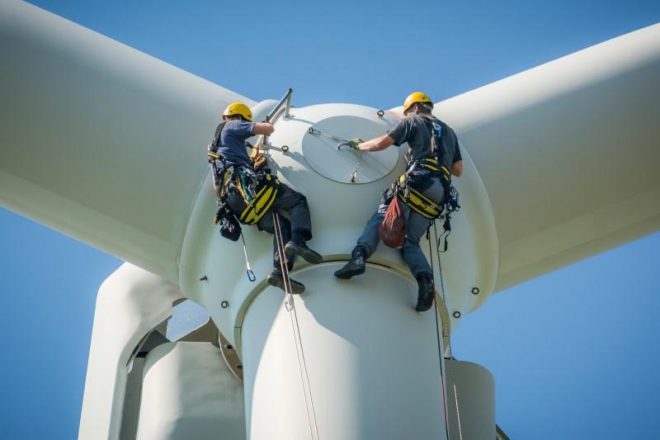 men working on a wind turbine