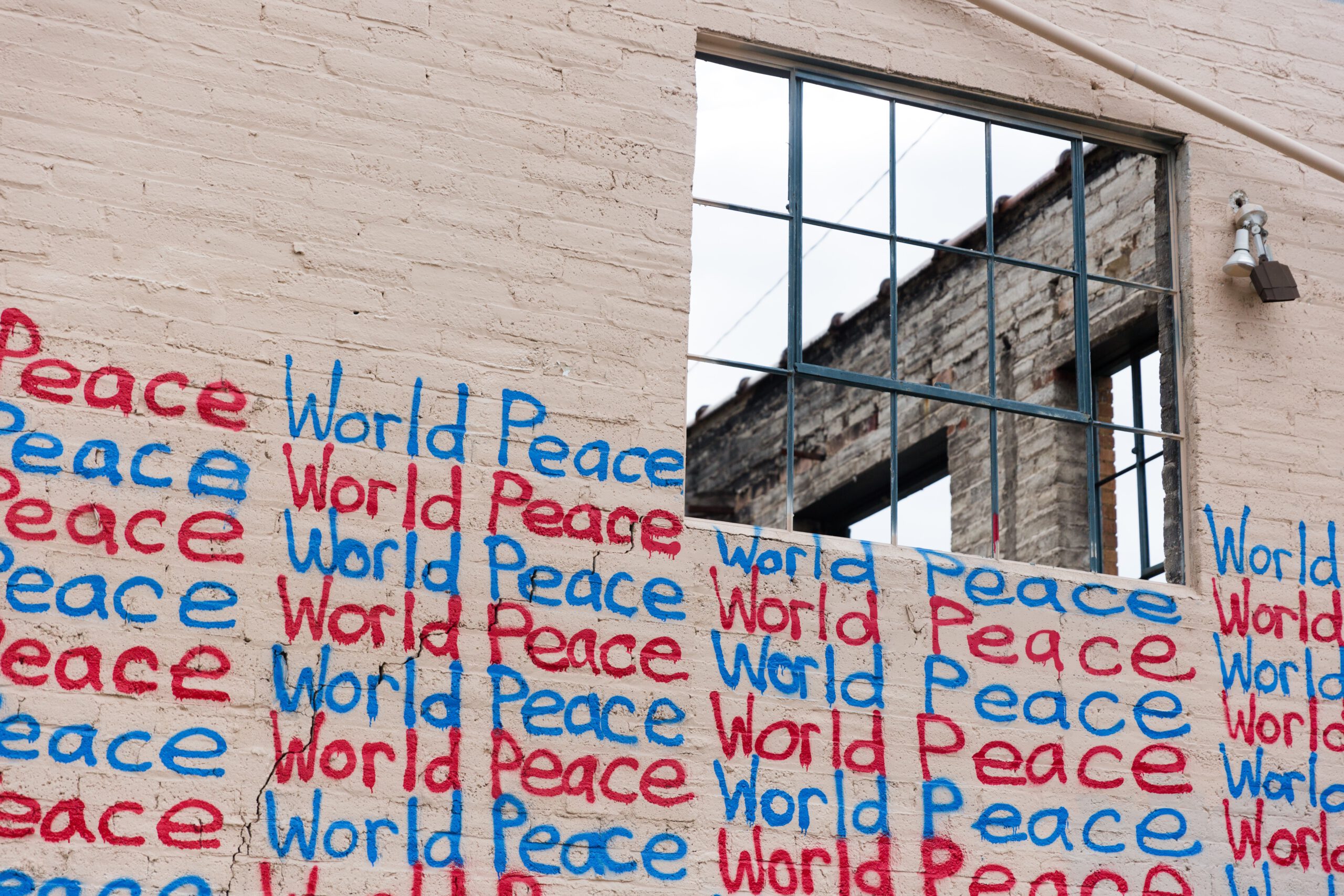 picture of a wall that says world peace