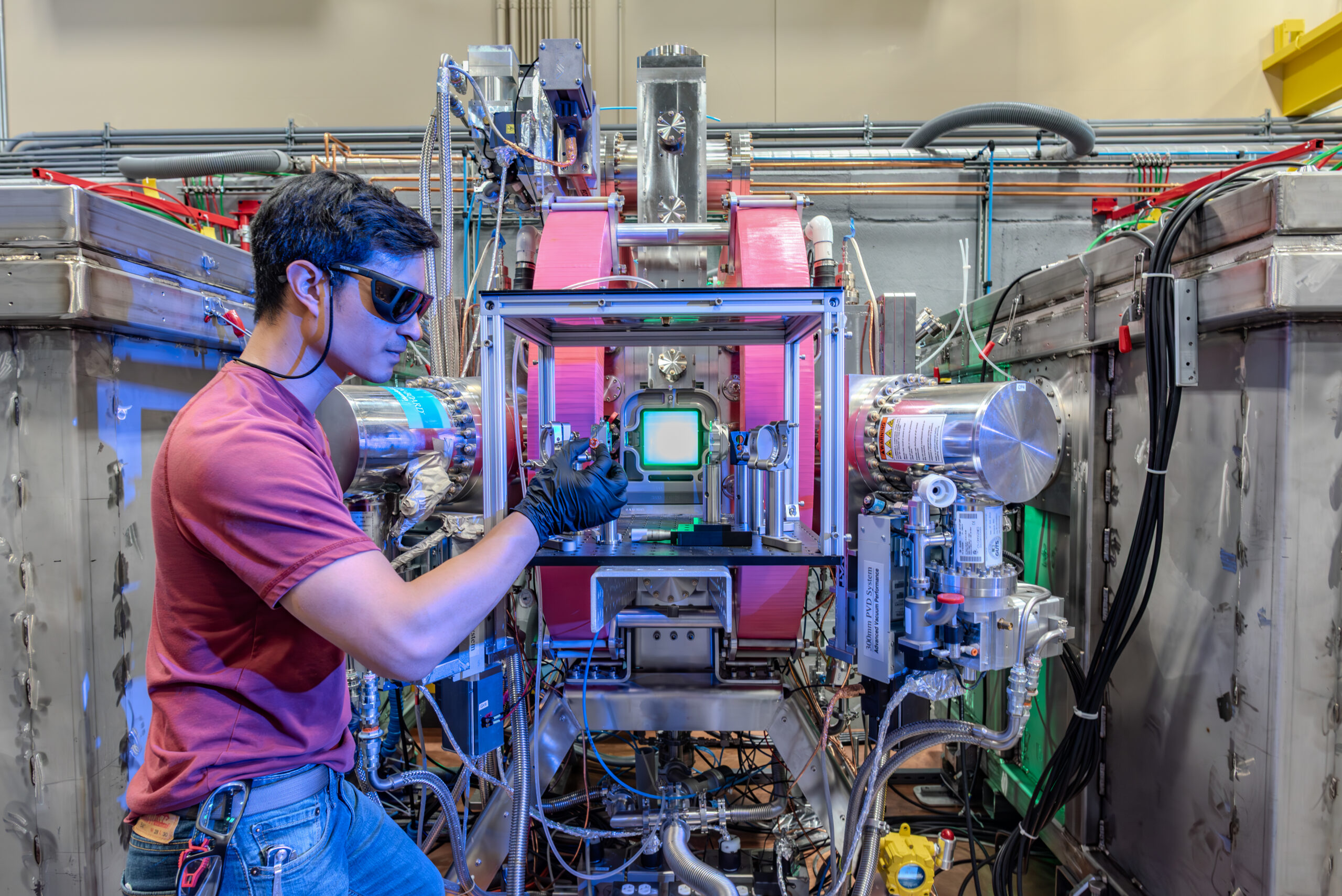 Jeffrey Villanueva working on the Long-Pulse Kinetics Platform laser amplifier at Xcimer Energy in Denver, Colorado. - Photo credit: Edward DeCroce